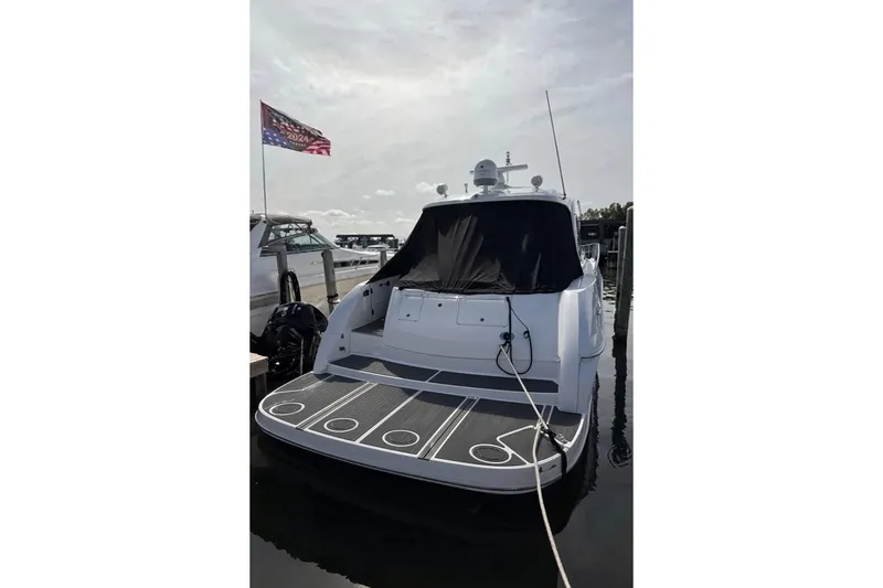 Slide: The Image of 2003 Sea Ray 500 Sundancer yacht docked at marina, rear view with American flag. - 4