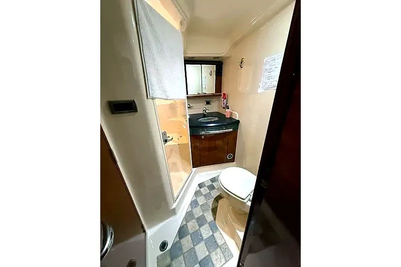 Slide: The Image of Bathroom interior of 2003 Sea Ray 500 Sundancer yacht, featuring sink and toilet. - 28