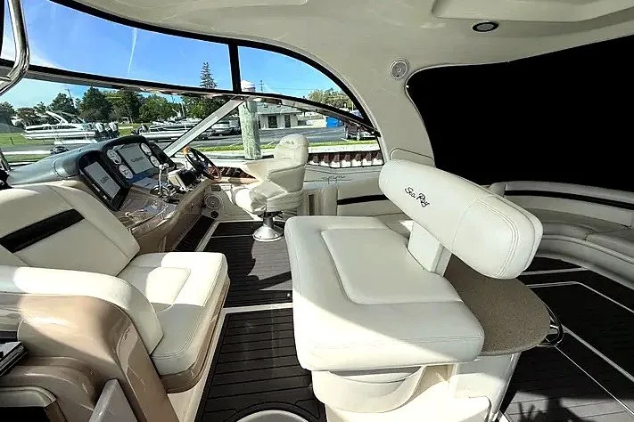 Slide: The Image of Luxurious interior of 2003 Sea Ray 500 Sundancer yacht with plush seating and modern dashboard. - 7
