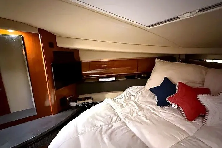 Slide: The Image of Luxurious cabin interior of 2003 Sea Ray 500 Sundancer with cozy bedding and modern amenities. - 21