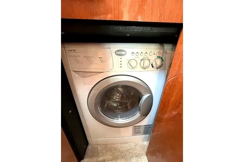 Slide: The Image of Compact washing machine inside 2003 Sea Ray 500 Sundancer yacht cabin. - 30