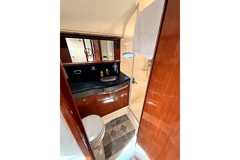 Slide: The Image of Luxurious bathroom in 2003 Sea Ray 500 Sundancer yacht with wood accents and modern fixtures. - 24