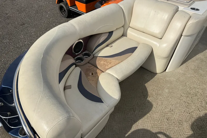 Slide: The Image of 2010 Sylvan 8525 Mandalay boat seating with cup holders and patterned upholstery. - 8