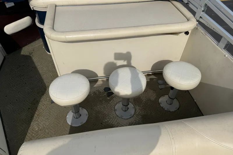 Slide: The Image of Three white stools on a 2010 Sylvan 8525 Mandalay boat deck. - 13