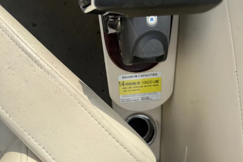 Slide: The Image of 2010 Sylvan 8525 Mandalay boat capacity label, showing 14-person or 1920 lbs limit. - 5