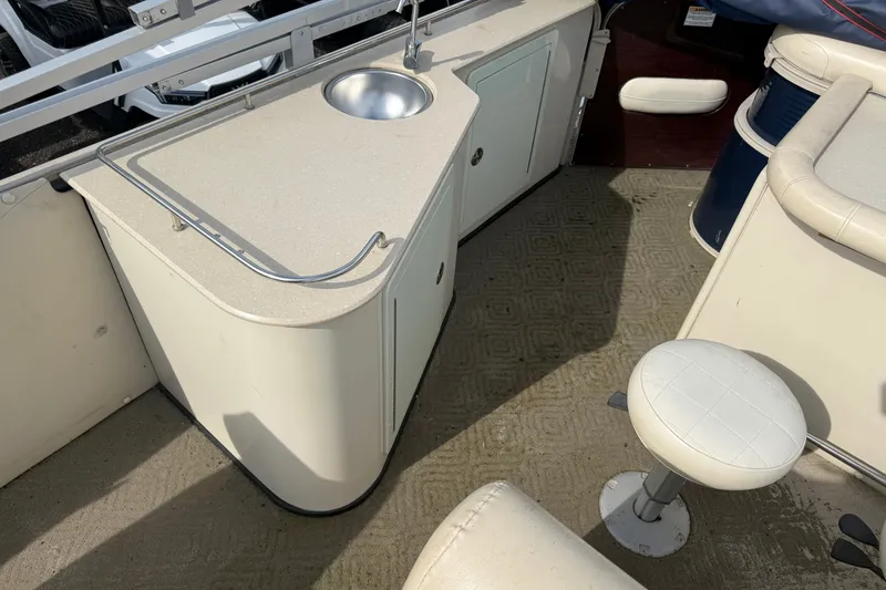 Slide: The Image of 2010 Sylvan 8525 Mandalay boat interior with sink and seating area. - 14