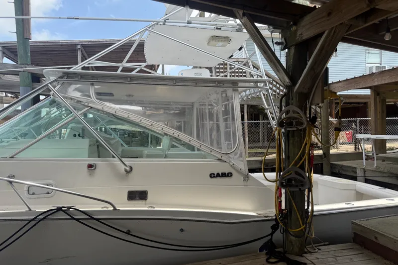 Slide: The Image of 1995 Cabo 35 Express boat docked, featuring sleek design and sturdy construction. - 5