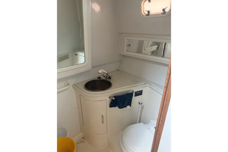 Slide: The Image of Bathroom interior of a 1995 Cabo 35 Express boat with sink and toilet. - 10