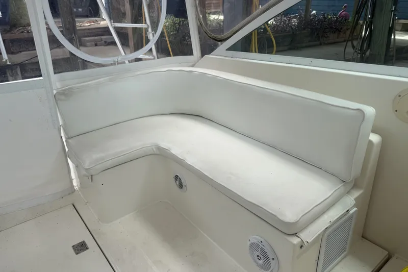 Slide: The Image of White cushioned seating on a 1995 Cabo 35 Express boat interior. - 14
