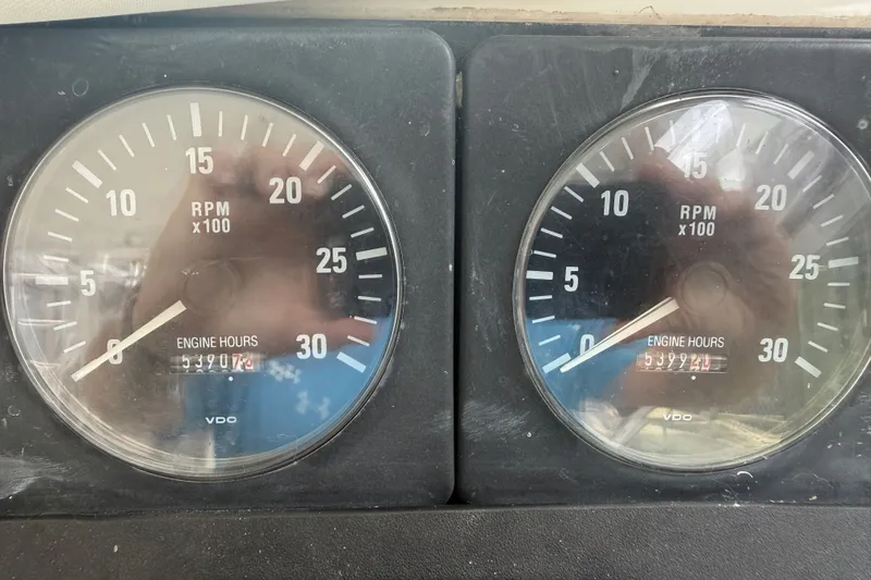 Slide: The Image of Tachometers displaying RPM and engine hours on a 1995 Cabo 35 Express boat. - 16