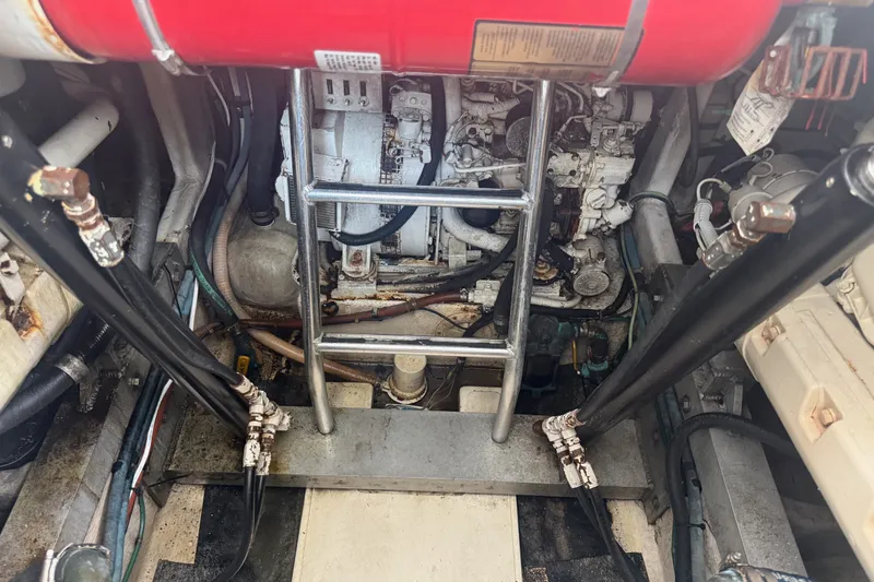 Slide: The Image of Engine compartment of a 1995 Cabo 35 Express boat with visible machinery and ladder. - 19