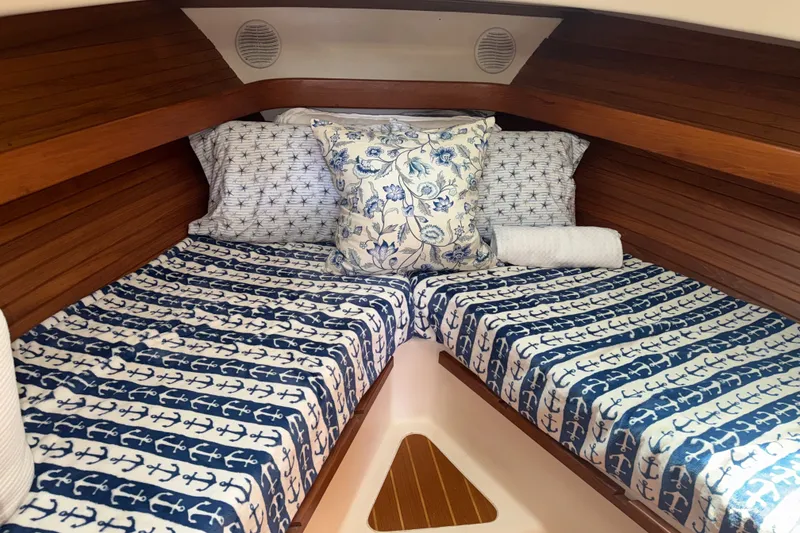 Slide: The Image of Cozy cabin interior of 2002 Mainship Pilot 34 with nautical-themed bedding. - 8