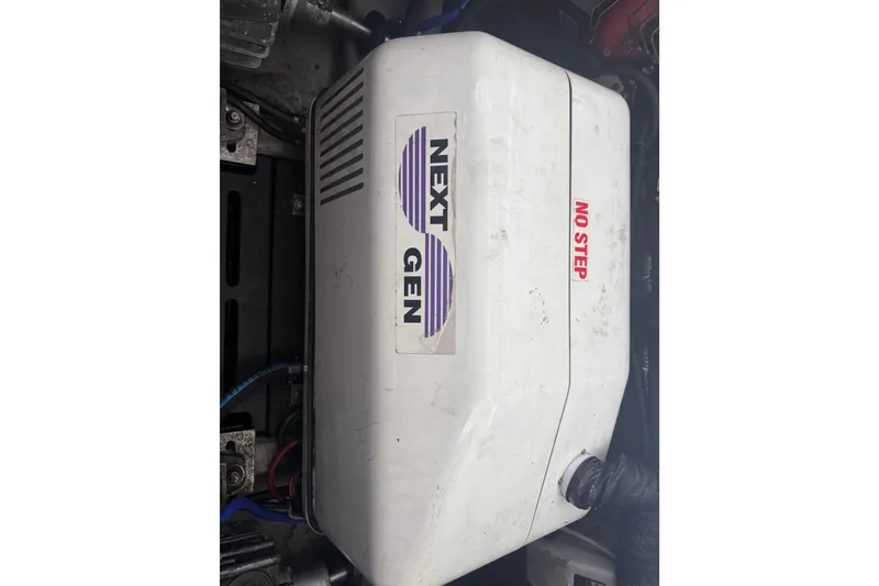 Slide: The Image of Engine compartment of a 2002 Mainship Pilot 34 with Next Gen generator. - 26