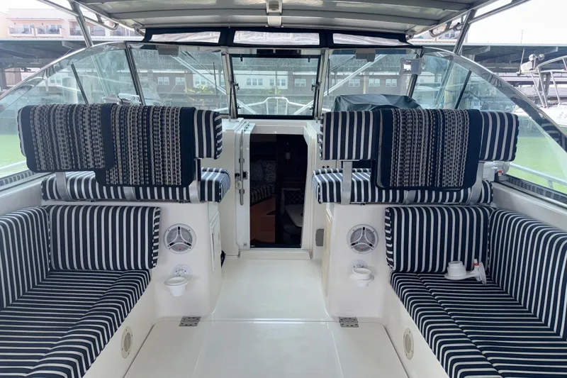 Slide: The Image of Interior of 2002 Mainship Pilot 34 boat with striped seating and open cabin door. - 19