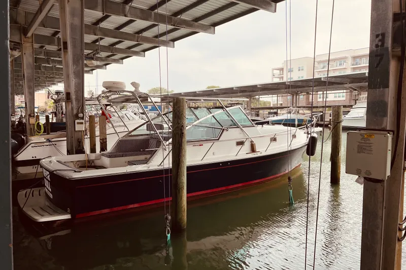 The Image of 2002 Mainship Pilot 34 docked in a covered marina. - 0
