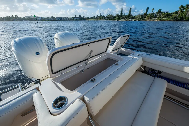 Slide: The Image of 2024 Grady-White Freedom 275 boat with open storage, dual engines, and scenic water view. - 16