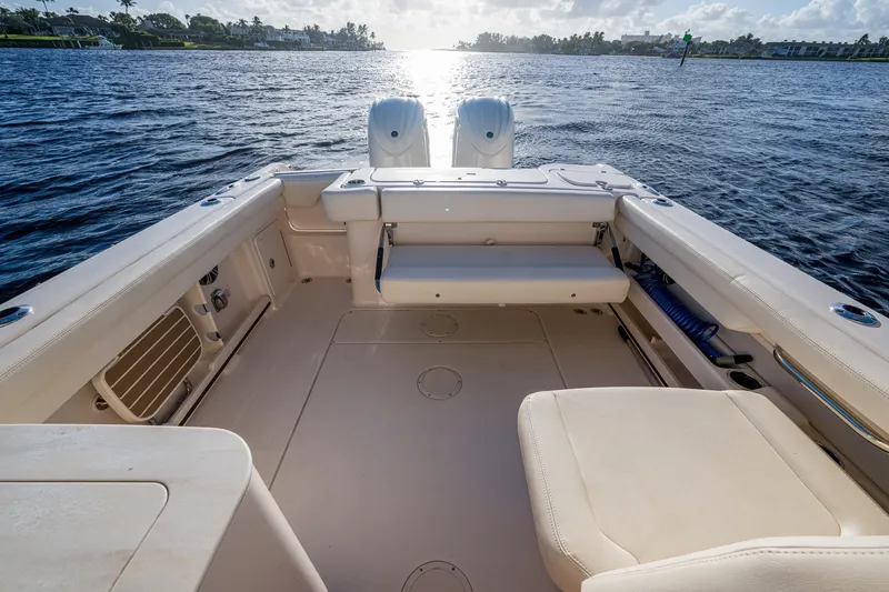 Slide: The Image of 2024 Grady-White Freedom 275 boat interior with seating, overlooking calm waters. - 17