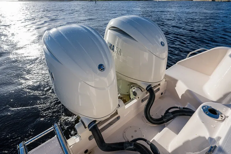 Slide: The Image of 2024 Grady-White Freedom 275 boat with dual Yamaha outboard engines on water. - 12