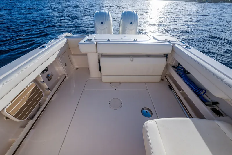 Slide: The Image of 2024 Grady-White Freedom 275 boat deck with seating, on open water. - 15