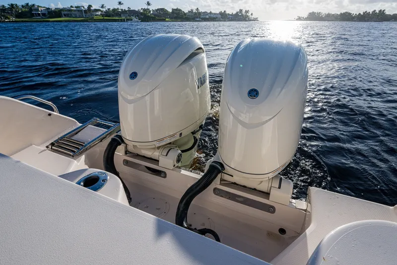 Slide: The Image of 2024 Grady-White Freedom 275 boat with dual outboard engines on water. - 10