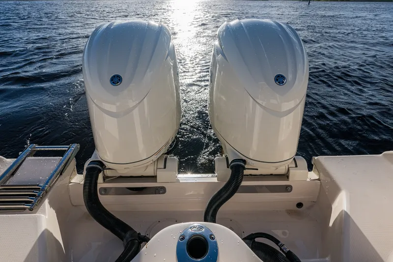 Slide: The Image of 2024 Grady-White Freedom 275 boat with dual outboard engines on water. - 11