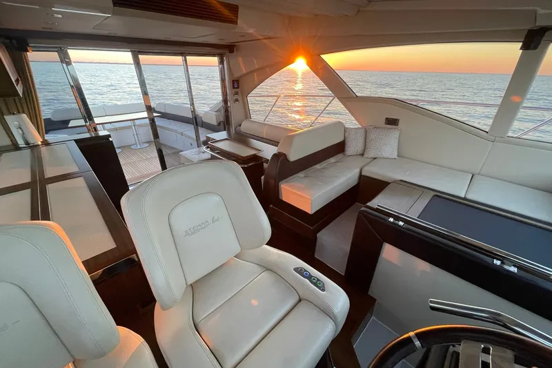 Slide: The Image of Luxurious interior of 2016 Azimut 55S yacht at sunset, featuring elegant seating and ocean view. - 13