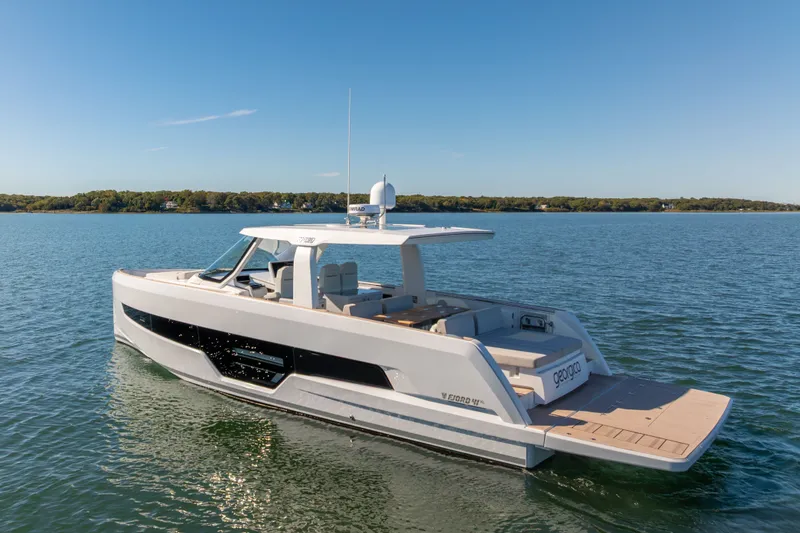 Slide: The Image of 2023 Fjord 41 XL yacht cruising on a serene lake under a clear blue sky. - 3