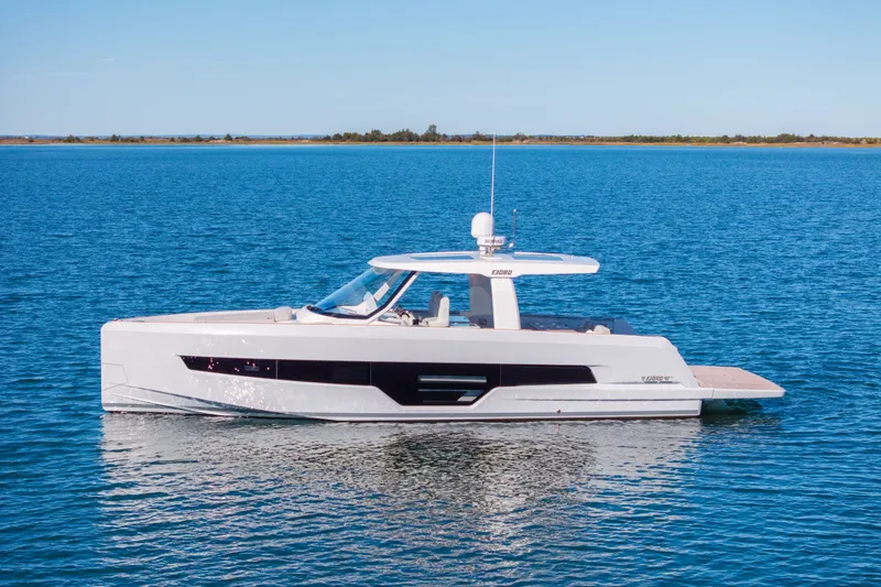 Slide: The Image of 2023 Fjord 41 XL yacht on calm blue water, showcasing sleek design and modern features. - 1