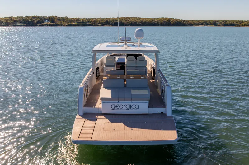 Slide: The Image of 2023 Fjord 41 XL yacht on calm water, rear view showcasing spacious deck. - 6