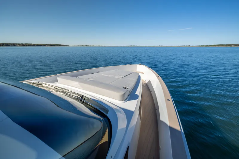Slide: The Image of 2023 Fjord 41 XL yacht cruising on calm blue waters under clear sky. - 45