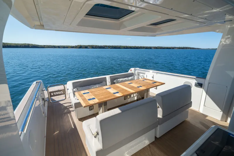 Slide: The Image of Luxurious 2023 Fjord 41 XL yacht deck with elegant seating and scenic ocean view. - 17