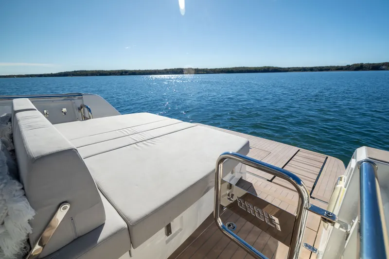 Slide: The Image of Luxurious 2023 Fjord 41 XL yacht deck with sunbed overlooking serene blue waters. - 20