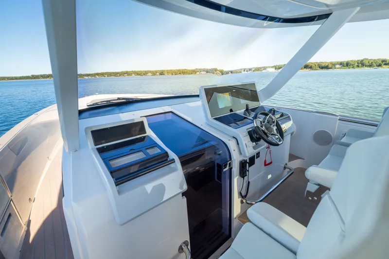 Slide: The Image of 2023 Fjord 41 XL yacht cockpit with modern steering and navigation system on calm water. - 38