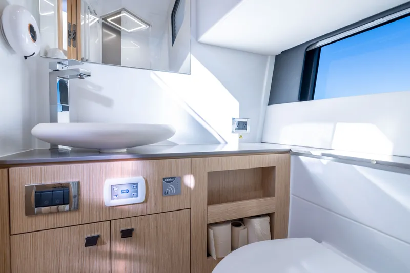 Slide: The Image of Modern bathroom interior of 2023 Fjord 41 XL yacht, featuring sleek sink and wooden cabinetry. - 47