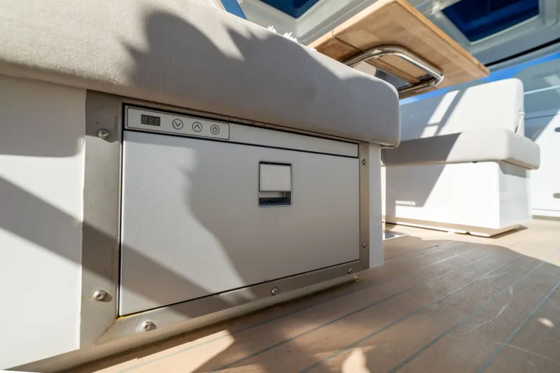 Slide: The Image of Interior of 2023 Fjord 41 XL yacht, featuring a built-in storage compartment and seating area. - 22