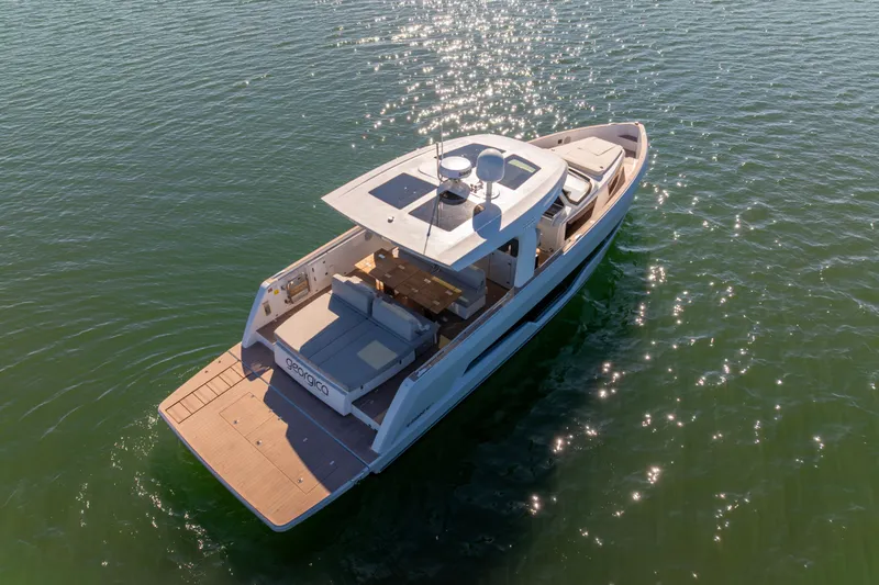 Slide: The Image of 2023 Fjord 41 XL yacht on sparkling water, showcasing sleek design and spacious deck. - 5
