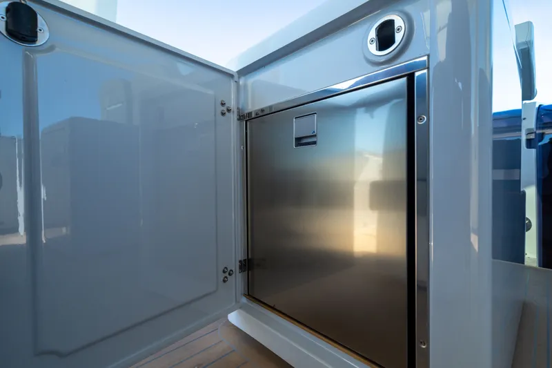 Slide: The Image of Open storage compartment on 2023 Fjord 41 XL yacht, featuring sleek stainless steel interior. - 30