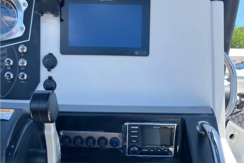 Slide: The Image of Control panel of a 2017 Scarab 195 ID boat with navigation and audio systems. - 16
