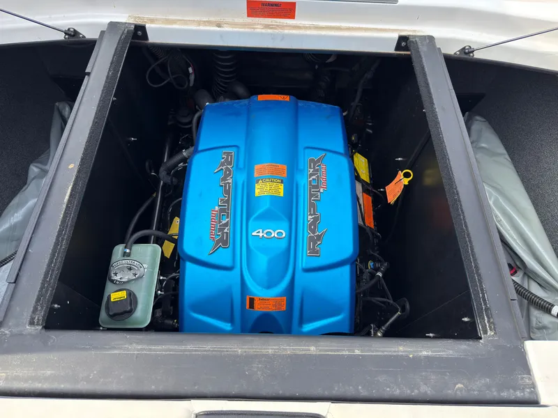 Slide: The Image of The engine compartment of a 2020 ATX Surf Boats 22 Type-S with a blue Raptor 400 engine. - 13
