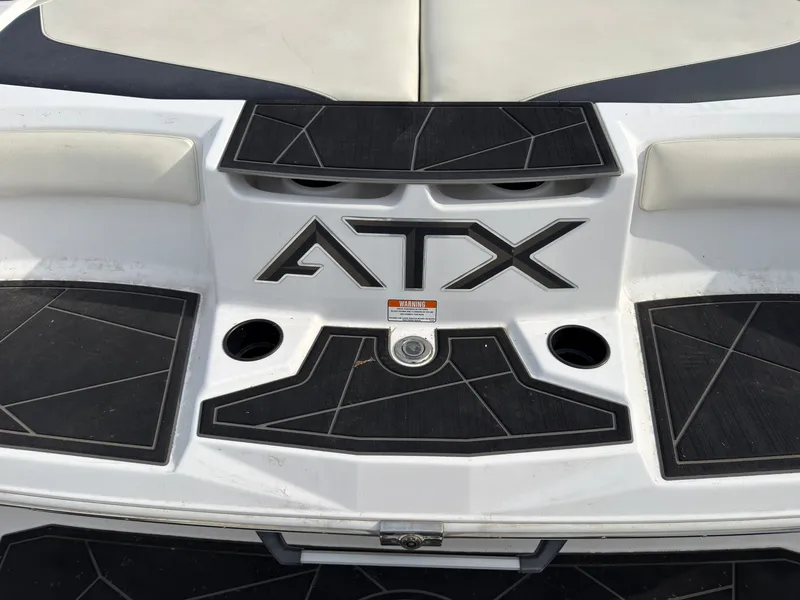 Slide: The Image of The stern of an ATX Surf Boat with stylish design and black accents. - 6