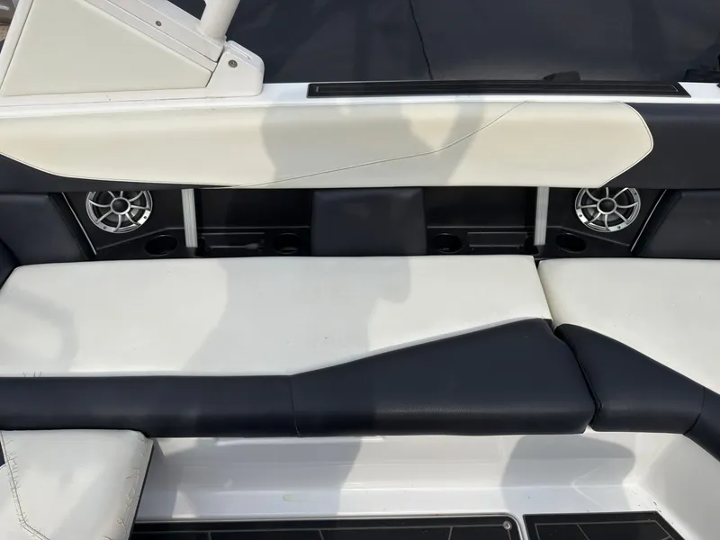 Slide: The Image of The 2020 ATX Surf Boats 22 Type-S bench features black and white upholstery and speakers. - 21