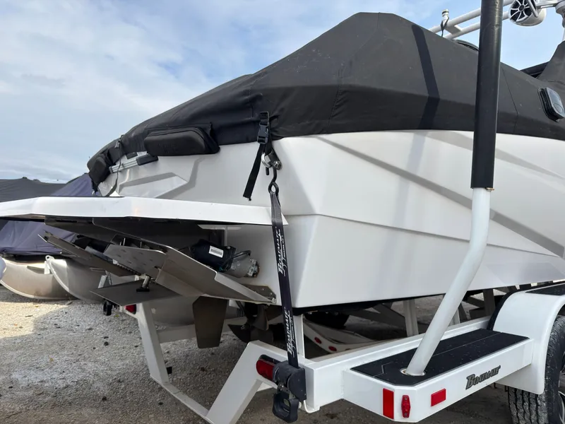 Slide: The Image of The image shows the rear of a white 2020 ATX Surf Boats 22 Type-S on a trailer. - 2