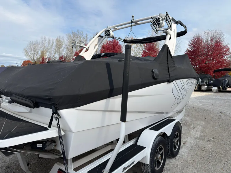 Slide: The Image of A white 2020 ATX Surf Boat 22 Type-S on a trailer, covered with a black tarp. - 1
