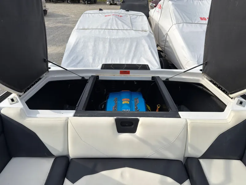 Slide: The Image of A 2020 ATX Surf Boat 22 Type-S with an open engine compartment. - 11