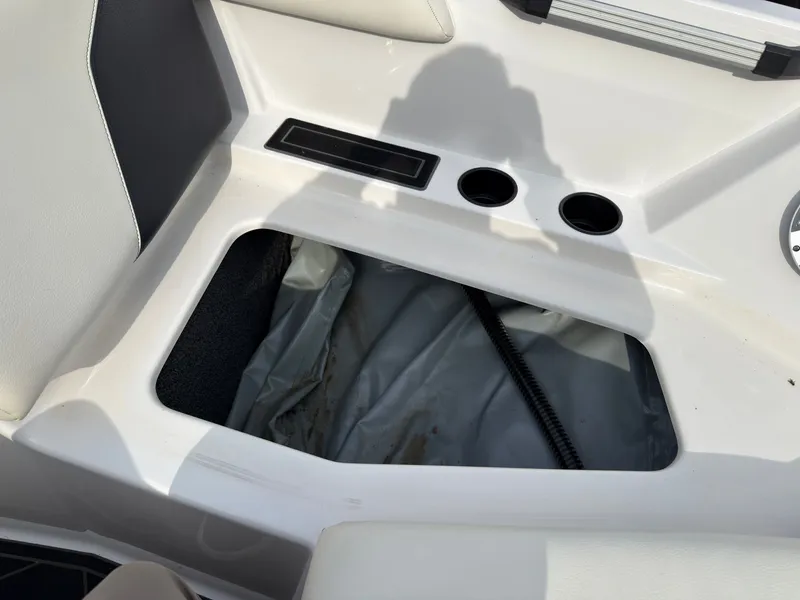 Slide: The Image of An open storage compartment in a boat with two cup holders beside it. - 37