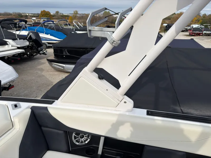 Slide: The Image of A 2020 ATX Surf Boat 22 Type-S with white and black interior, parked outdoors. - 20