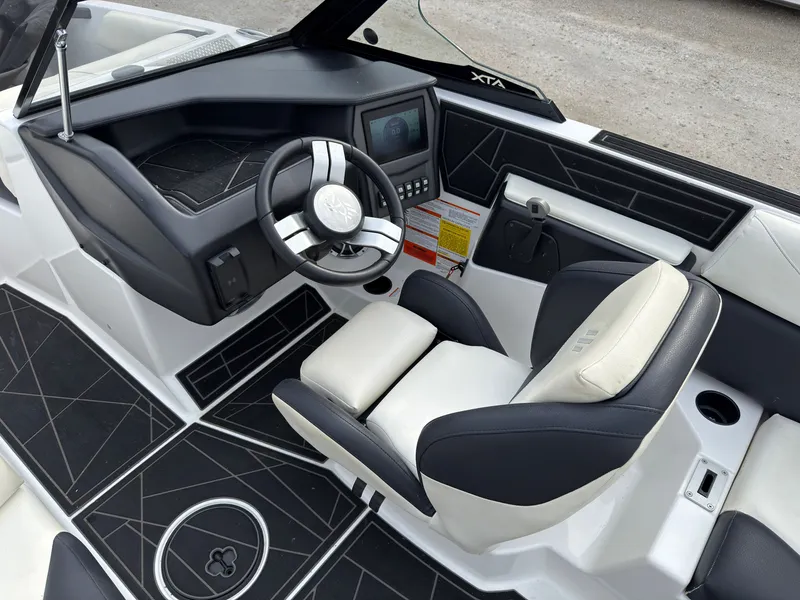 Slide: The Image of The image shows the cockpit of a 2020 ATX Surf Boats 22 Type-S with a modern steering wheel and seating. - 25