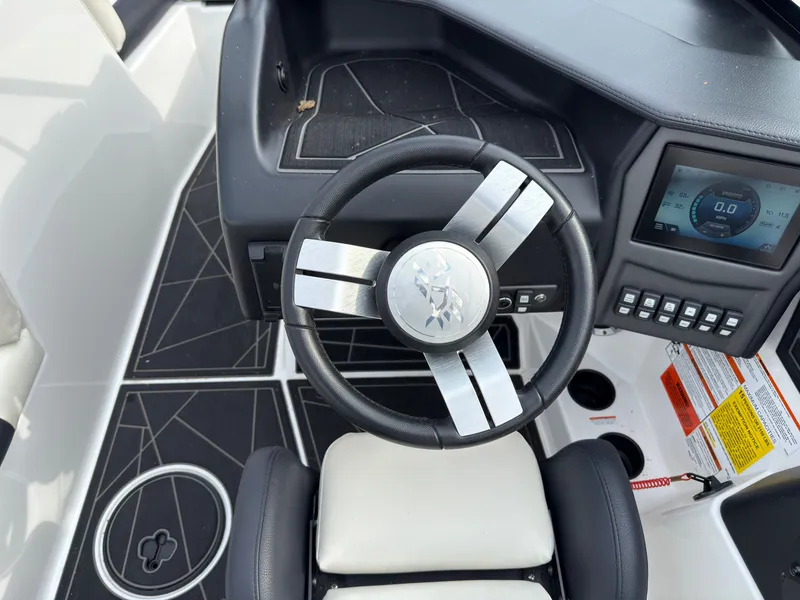 Slide: The Image of The cockpit of a 2020 ATX Surf Boats 22 Type-S with a modern steering wheel and instruments. - 28