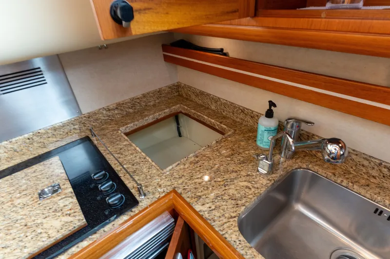 Slide: The Image of Luxurious galley in 2009 Grand Banks 45 Eastbay SX with granite countertops and modern fixtures. - 56