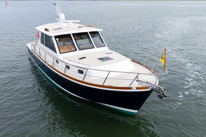 Slide: The Image of 2009 Grand Banks 45 Eastbay SX yacht on calm water, showcasing sleek design and craftsmanship. - 88